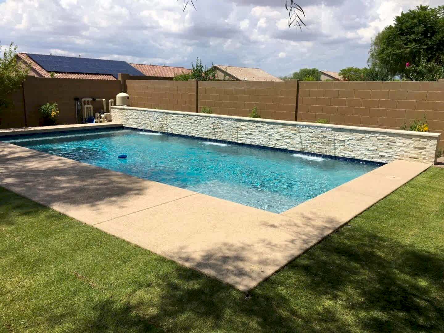 A pool that is in the middle of some grass.