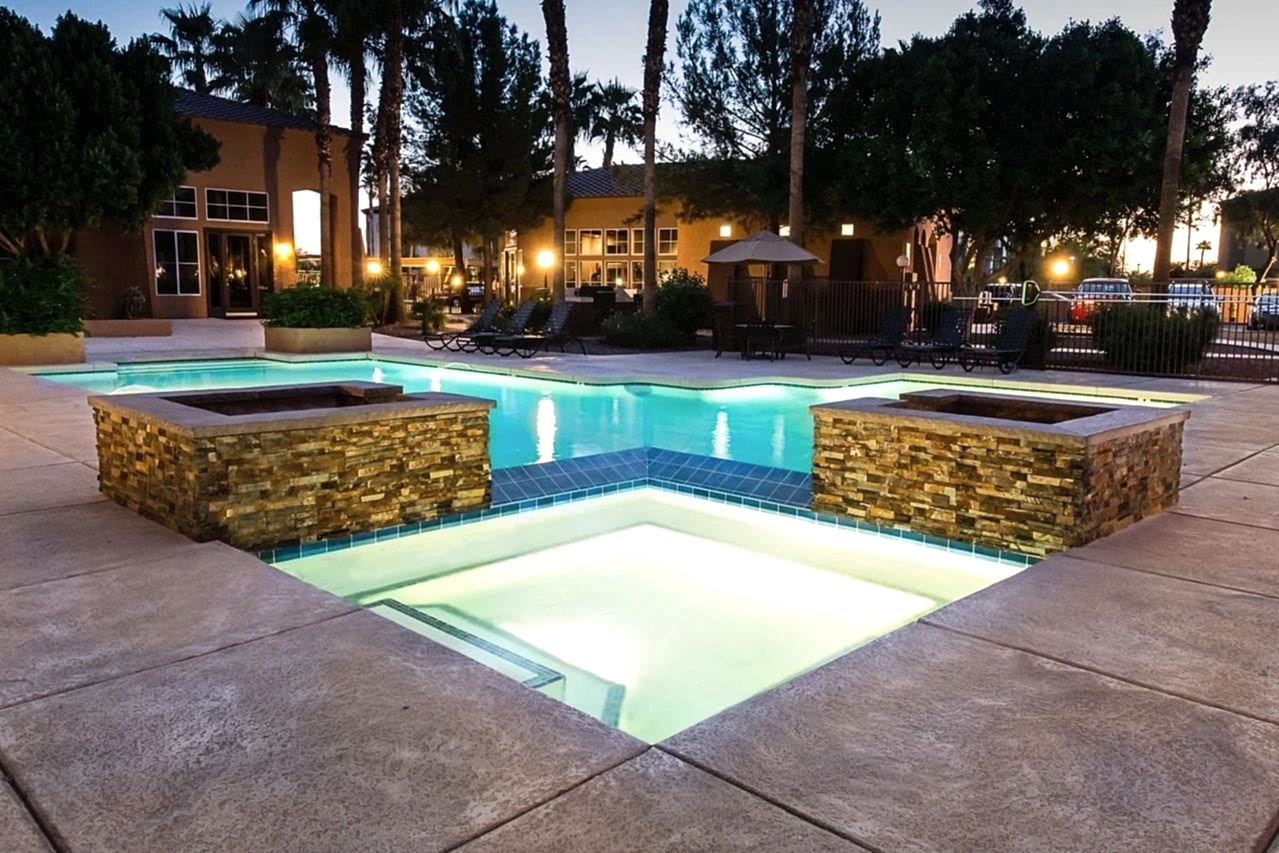 A pool with lights on in the middle of it.
