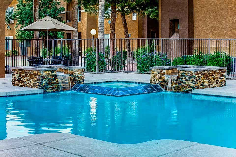 Apartment pool with water features.