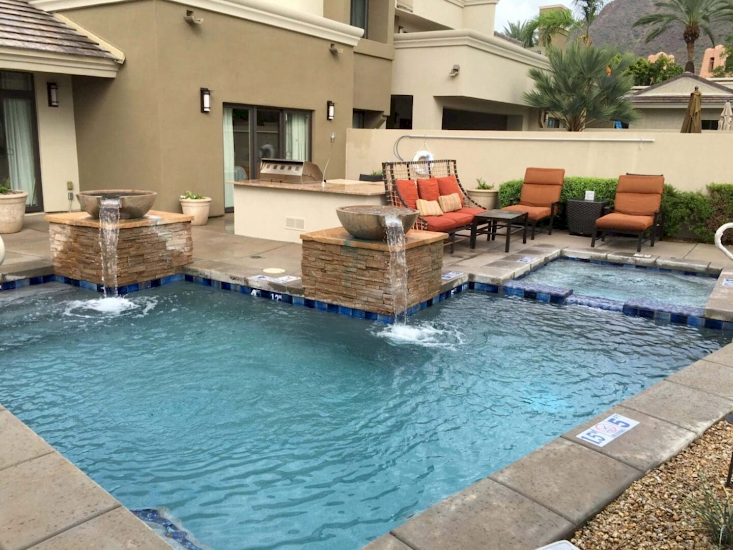 Resort pool with fountains and hot tub.