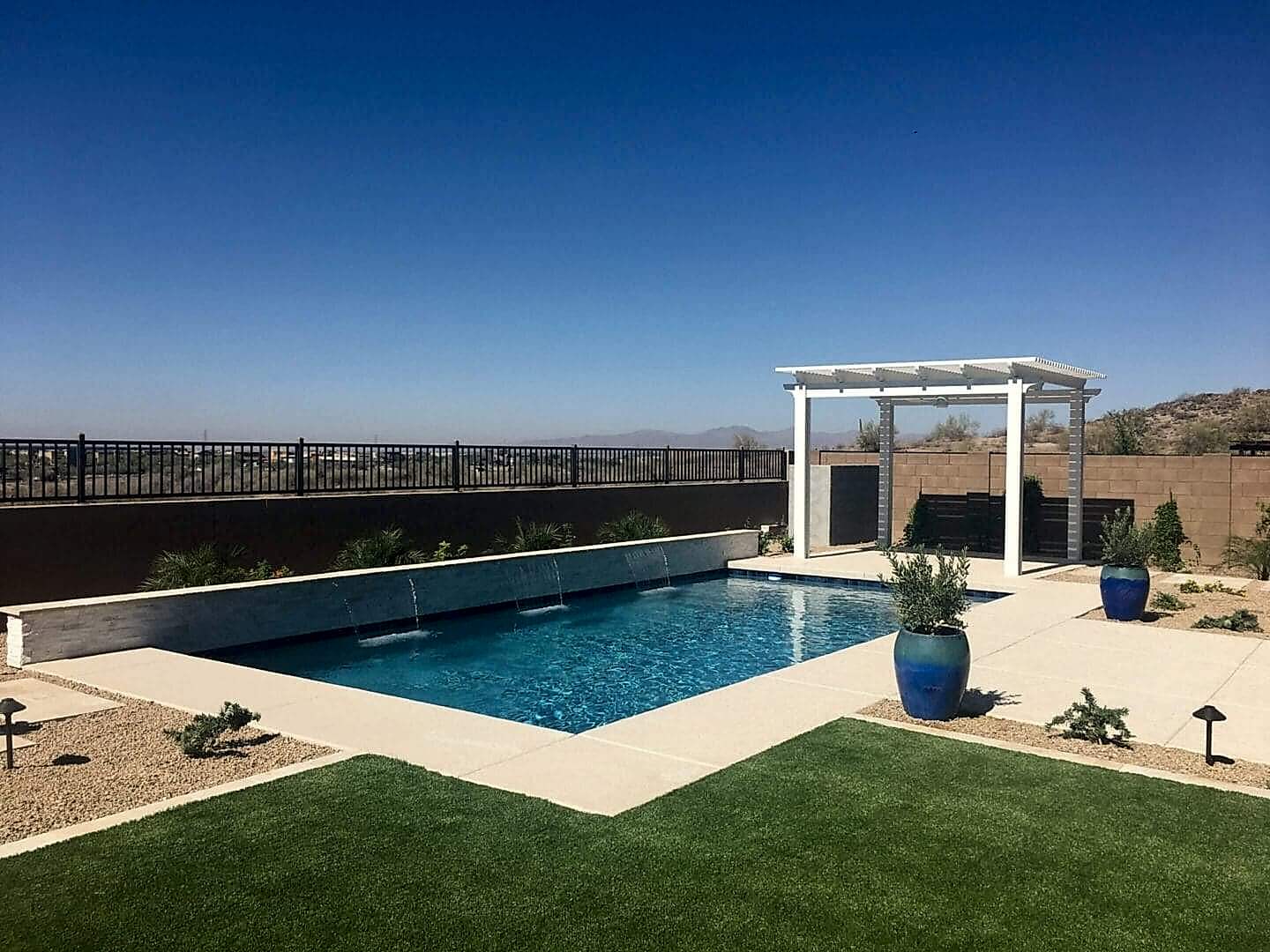 Modern backyard pool with pergola.