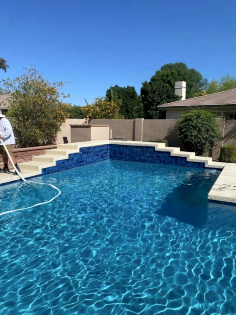 Pool cleaning, blue water, sunny day.