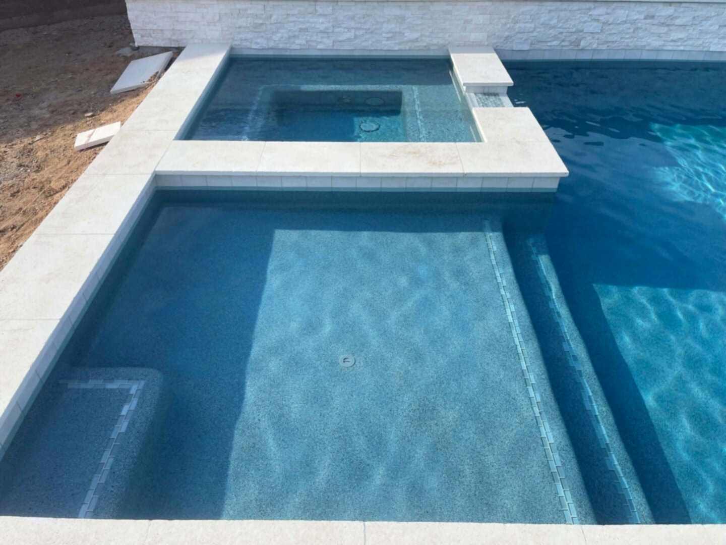 Modern pool with built-in spa.
