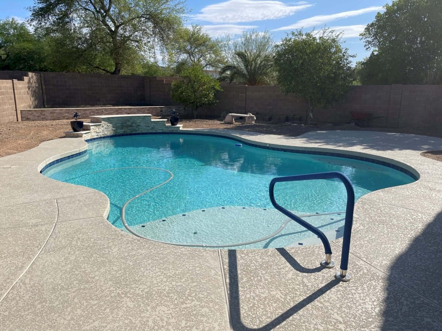 Freeform swimming pool with blue water.