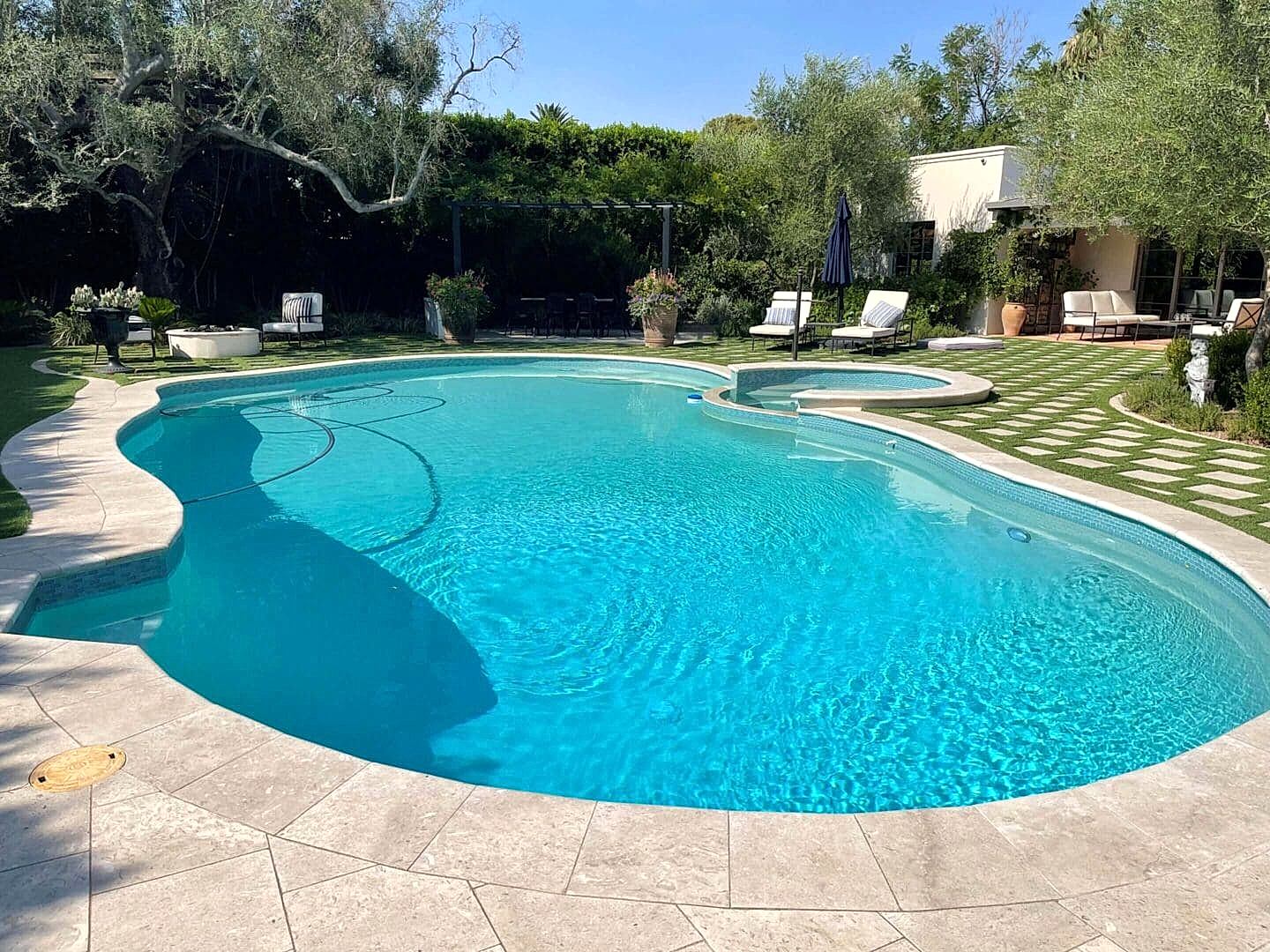 Here's an alt tag for the image: "Luxury backyard pool and patio"