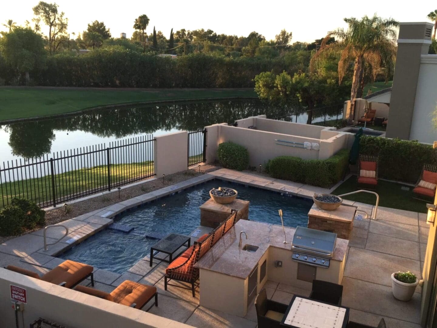 Luxury backyard pool with outdoor kitchen.