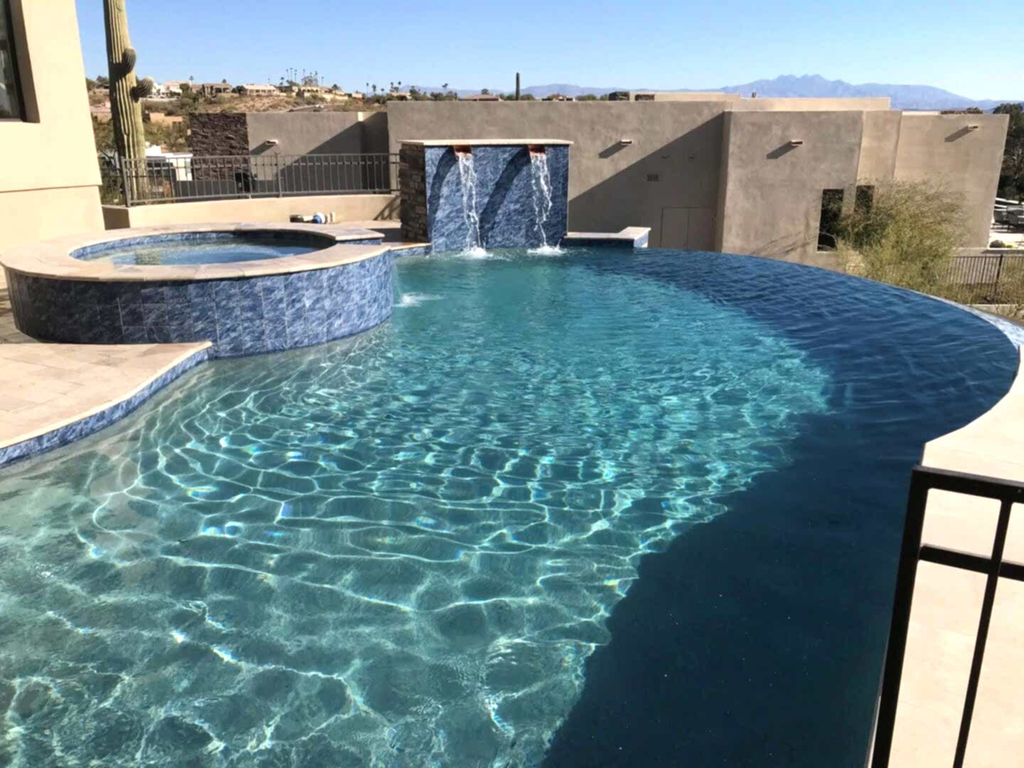 Luxury pool and spa with waterfall.