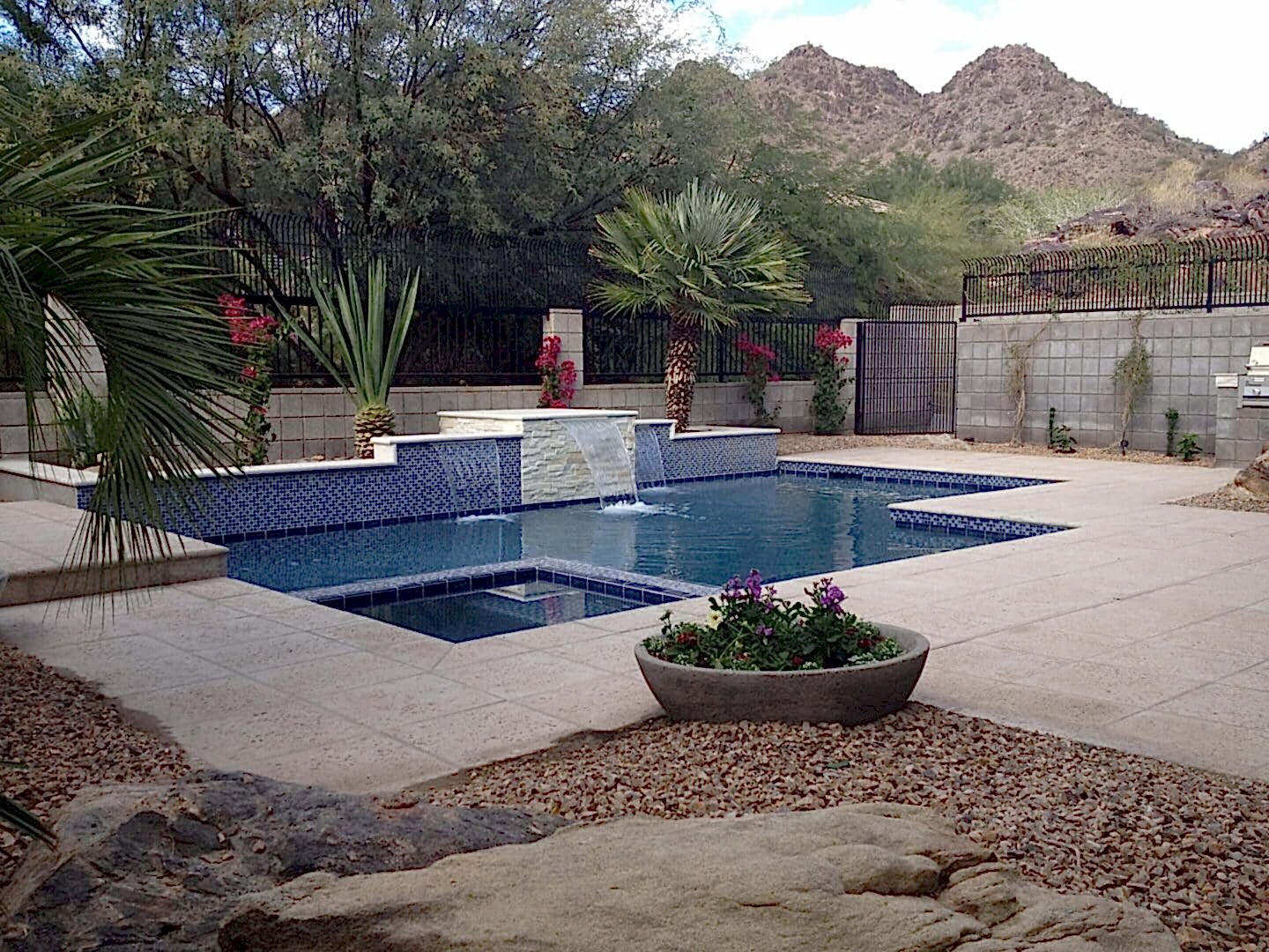 Mountain view pool with waterfall feature.