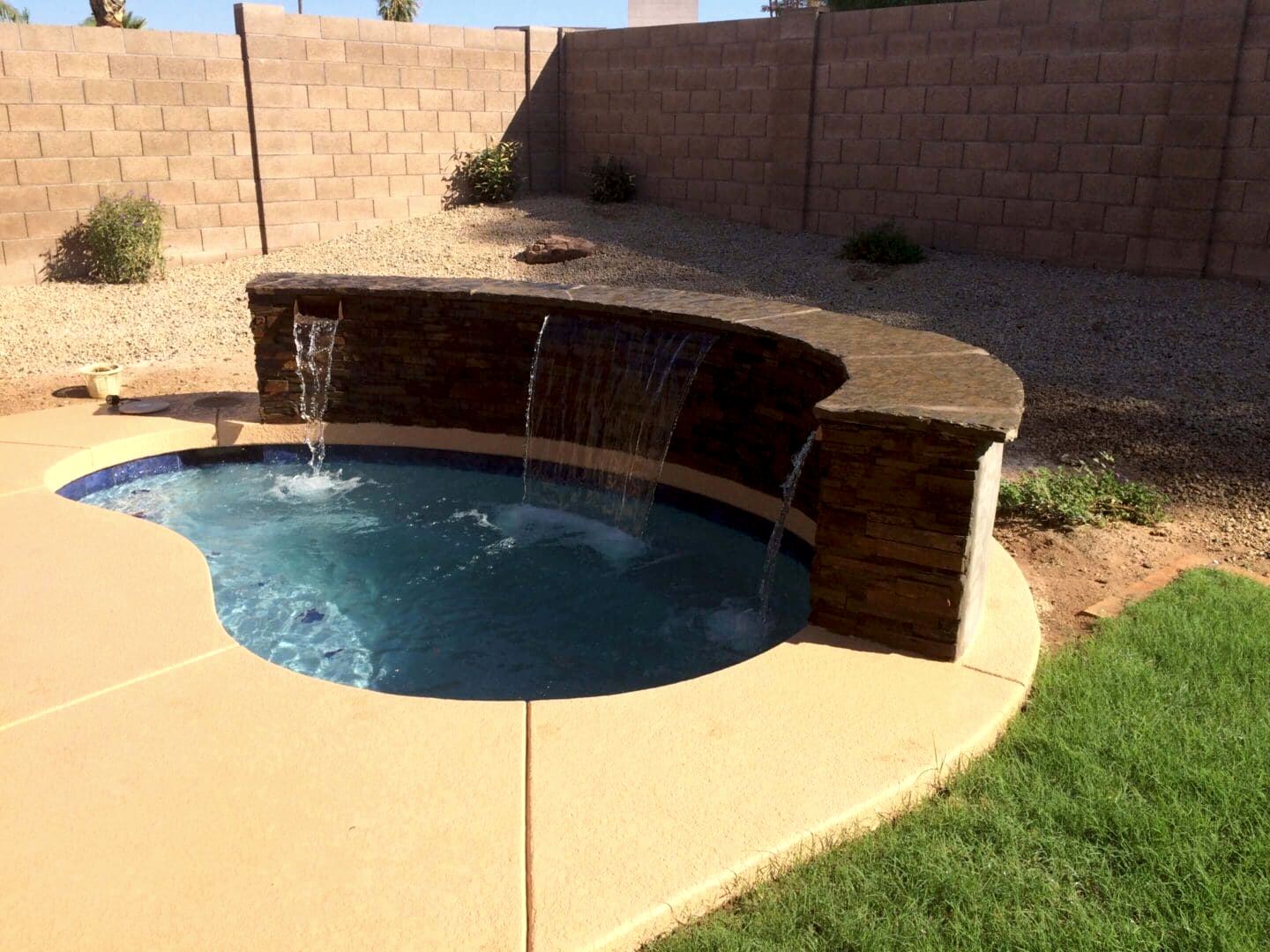 Stone waterfall into small pool.