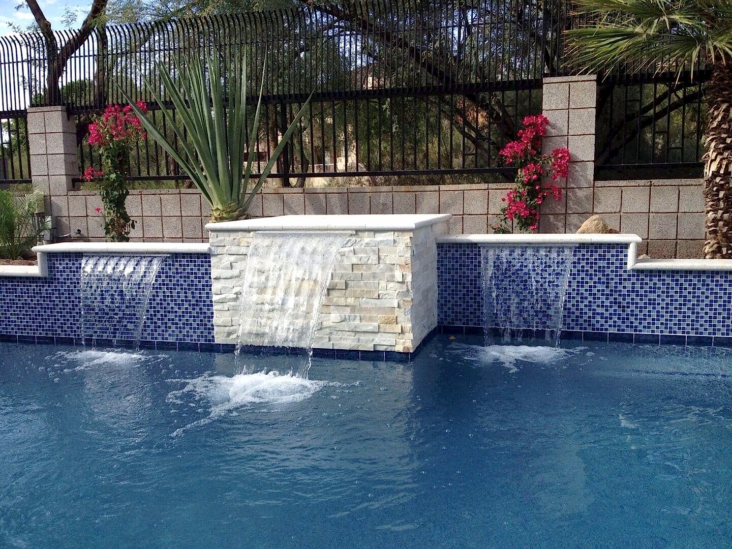 Pool waterfall feature with stonework.